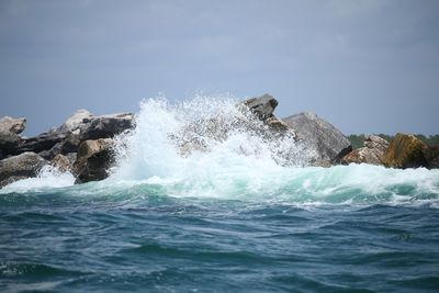 Ocean wave crashing on rocks