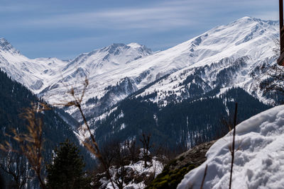 Scenic view of snowcapped mountains against sky