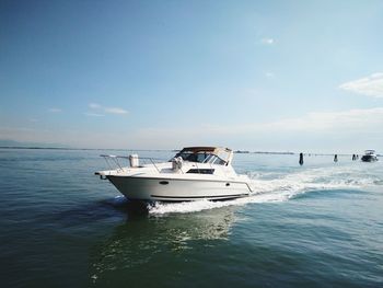 Boat sailing in sea against sky