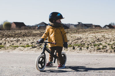 Boy riding bicycle on road