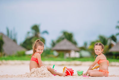 Portrait of smiling mother and daughter at beach