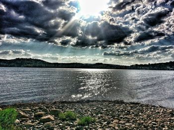 Scenic view of river against cloudy sky