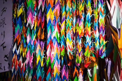 Full frame shot of multi colored decorations hanging on wall