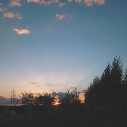 Silhouette trees against sky during sunset