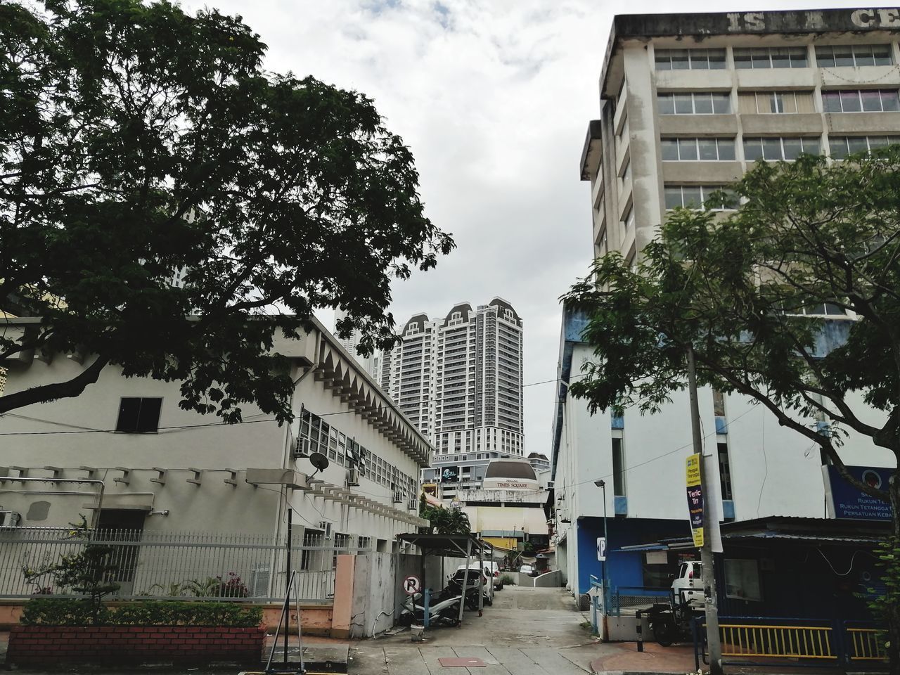 STREET BY BUILDINGS AGAINST SKY