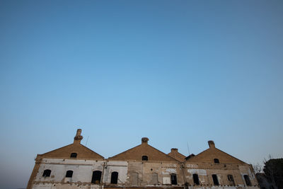 Low angle view of historic building against clear blue sky