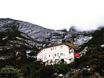 Built structure on mountain against sky