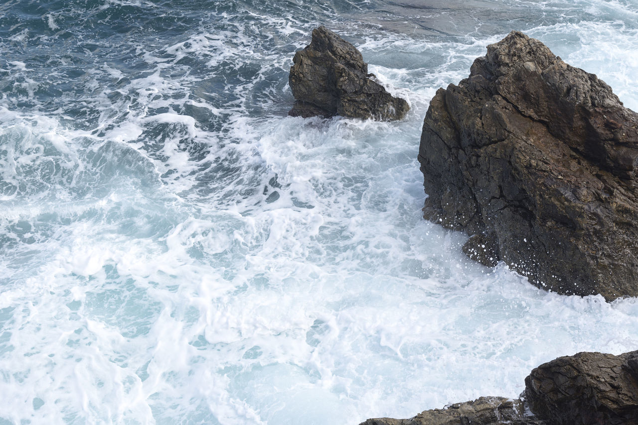 WAVES BREAKING ON ROCKS