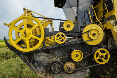 Low angle view of yellow machinery on field