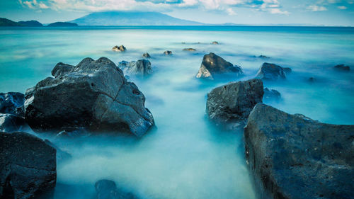Panoramic view of sea and rocks against sky