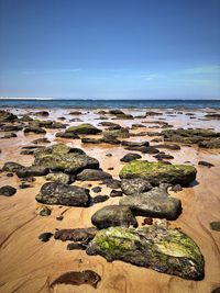 Aerial view of rocks on beach against sky