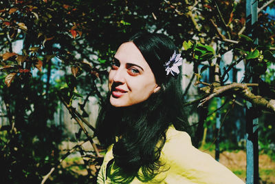 Portrait of woman against plants