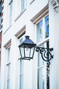 Low angle view of street light against building