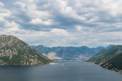 Scenic view of sea and mountains against sky