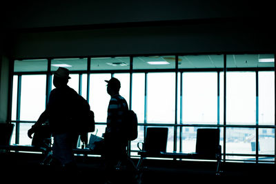 Silhouette people walking in airport