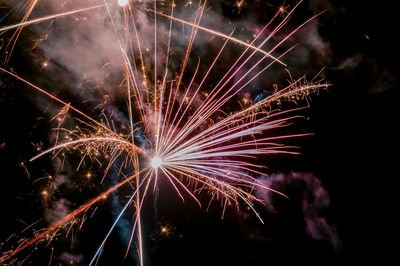 Low angle view of firework display at night