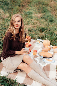 Portrait of young woman sitting outdoors