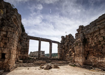 View of old ruin building against cloudy sky