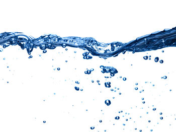 Close-up of splashing water against white background