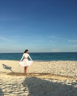 Full length of girl standing at beach