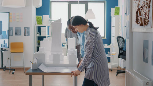 Side view of woman standing in office