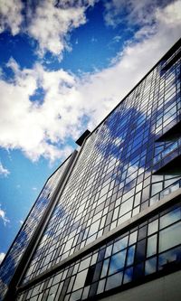 Low angle view of modern building against blue sky