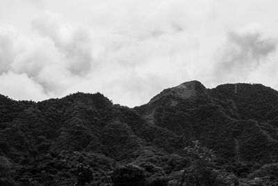 Scenic view of mountains against cloudy sky