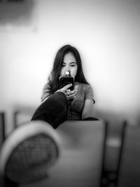 Young woman using mobile phone at home