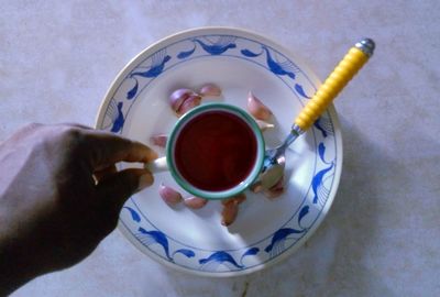 Close-up of hand holding coffee cup