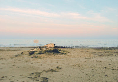 Scenic view of beach against sky during sunset