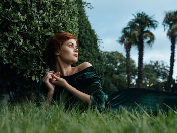 Young woman relaxing on field