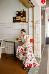 Portrait of woman sitting on chair