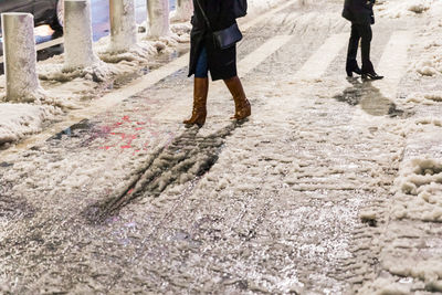 Low section of people walking on road