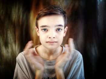 Close-up portrait of boy applauding