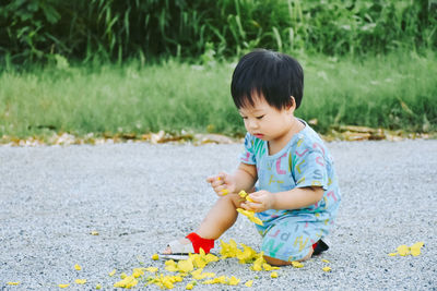 Cute boy playing with toy in park