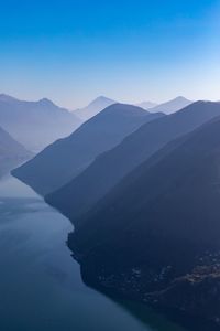 Scenic view of mountains against blue sky