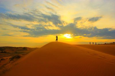 Scenic view of beach against sky during sunset