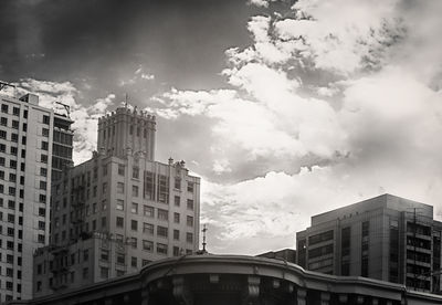 Low angle view of building against cloudy sky