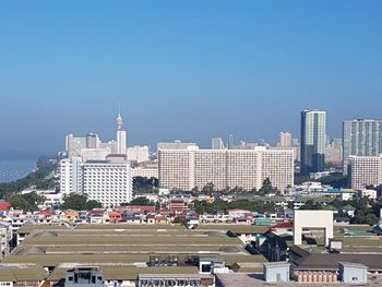 Buildings in city against blue sky