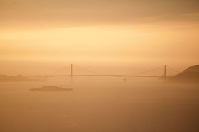 View of suspension bridge against sky during sunset