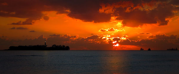 Scenic view of sea against romantic sky at sunset