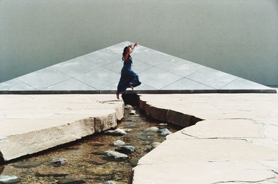 High angle view of woman walking on concrete floor