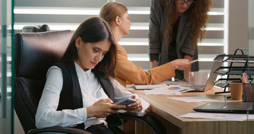 Stressed business accountant typing using cellphone, feeling confused of message 