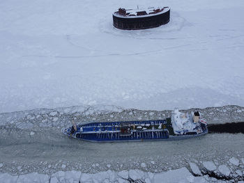 High angle view of snow covered boat on frozen water