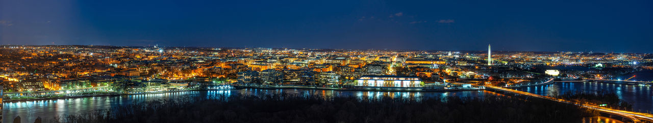 High angle view of illuminated buildings against sky at night