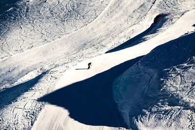 High angle view of person skiing on snowcapped mountain