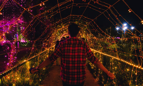 Rear view of man standing in tunnel