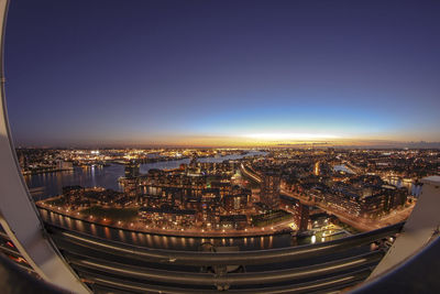 High angle view of city lit up at night