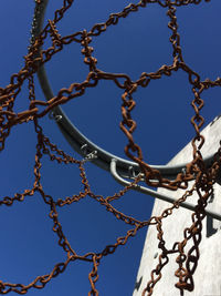 Low angle view of chain against clear sky