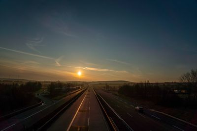 Highway against sky during sunset